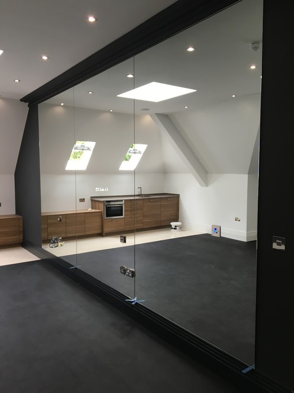 Frameless glass partition in loft conversion by Bellingham glaziers