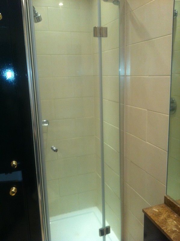 Frameless glass shower enclosure with chrome fittings in Bellingham